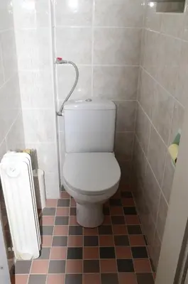 a bathroom with a toilet and a tiled floor at Flower valley in Ljubljana