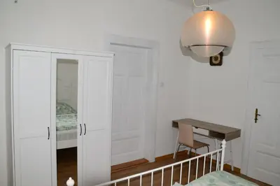 a room with a desk and a mirror and a lamp at Flower valley in Ljubljana