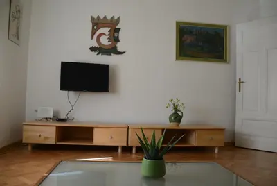 a living room with a television and a table at Flower valley in Ljubljana
