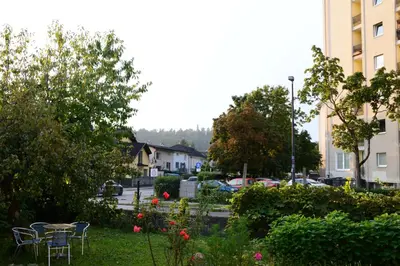 a garden with a table and chairs in a city at Flower valley in Ljubljana