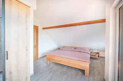 a bedroom with a bed in a room at Apartment & Room Pristov in Žirovnica