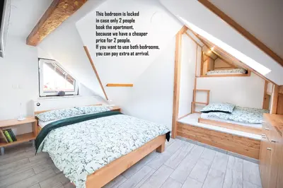 a small bedroom with a bed and a window at Apartment & Room Pristov in Žirovnica