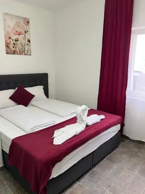 a bedroom with a bed with white towels on it at Panda Rooms in Maribor