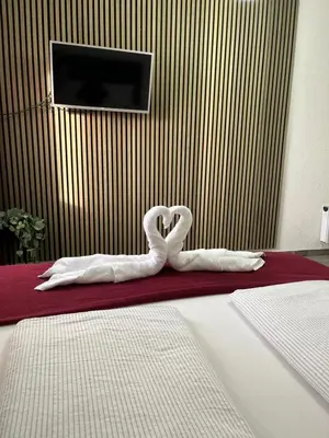 a swan decoration in the middle of a bedroom at Panda Rooms in Maribor
