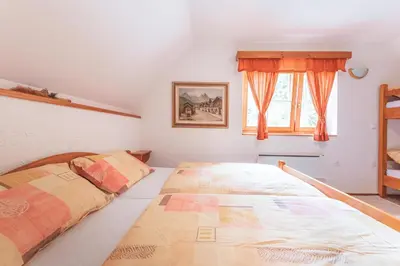 a bedroom with two beds and a window at POHORJE HOUSE Rogla 2 in Oplotnica