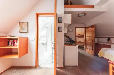 a kitchen with an open door to a room at POHORJE HOUSE Rogla 2 in Oplotnica