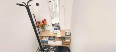 a mirror in a room with a broom and flowers at JO-MA apartma - SAFE parking in Koseze