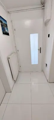 a white room with a door and a window at JO-MA apartma - SAFE parking in Koseze