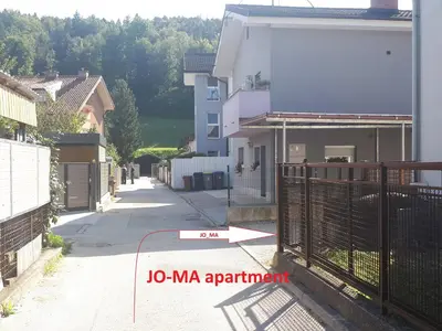 a building with a sign that reads ma apartment at JO-MA apartma - SAFE parking in Koseze