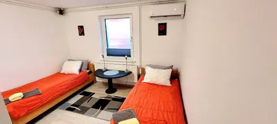 two beds in a room with a window at JO-MA apartma - SAFE parking in Koseze