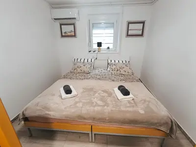 a bedroom with a large bed with two phones on it at JO-MA apartma - SAFE parking in Koseze