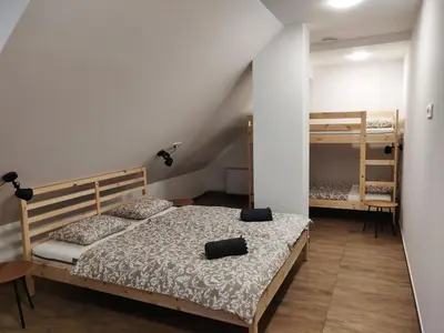 a bedroom with a bed and two bunk beds at PUBYLAND ROOMS & APARTMENTS in Rogatec