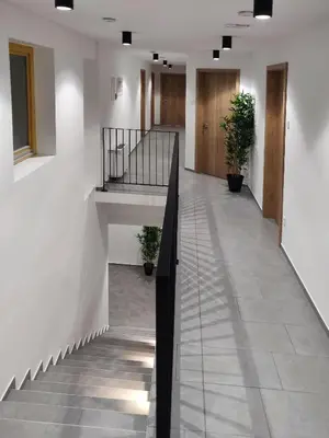 a hallway with a staircase in a building at PUBYLAND ROOMS & APARTMENTS in Rogatec