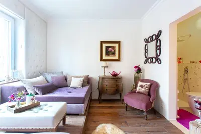 a living room with purple furniture and a couch at NEW, Stylish and modern central Studio, FREE parking in Celje