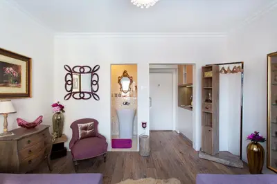 a living room with a chair and a table at NEW, Stylish and modern central Studio, FREE parking in Celje