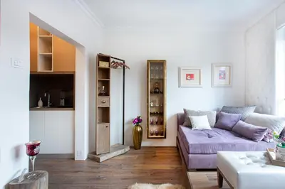 a living room with a purple couch and a table at NEW, Stylish and modern central Studio, FREE parking in Celje