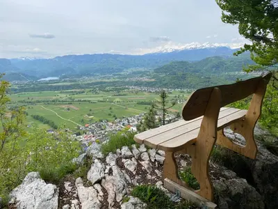 a wooden bench sitting on top of a mountain at Apartment Ajdna in Žirovnica
