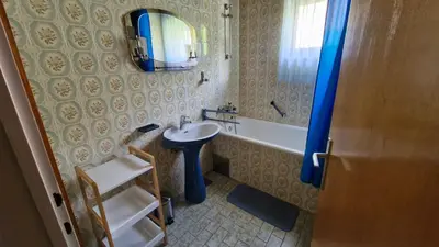 a bathroom with a sink and a bath tub at Apartment Ajdna in Žirovnica