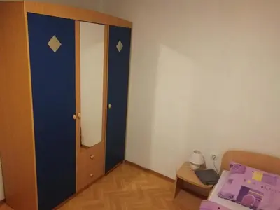 a bedroom with a blue door and a bed at Apartment House Papa in Vinica
