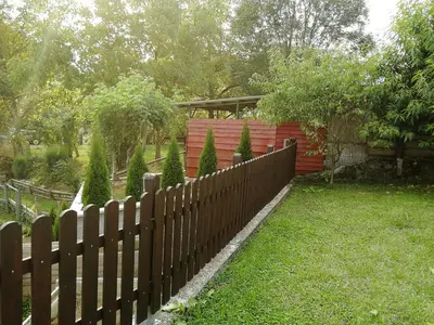 a wooden fence in front of a house at Apartment House Papa in Vinica