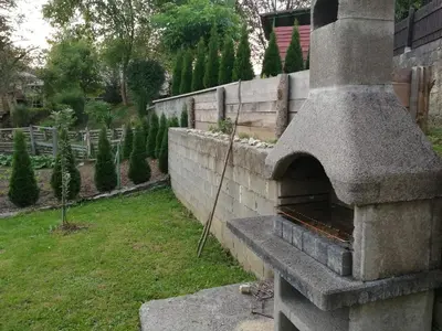 a stone oven in a yard with a garden at Apartment House Papa in Vinica