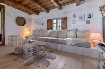 a living room with a large couch and a table at Domačija Pri Momi in Križevci