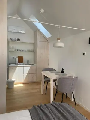 a kitchen and dining room with a table and chairs at Domačija Pri Momi in Križevci