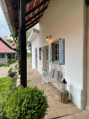 a patio with a chair and a window at Domačija Pri Momi in Križevci
