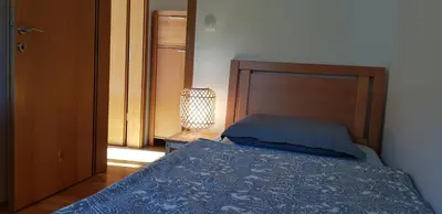 a bedroom with a bed with a wooden head board at Mountain peaks Apartment with Sauna in Gozd Martuljek