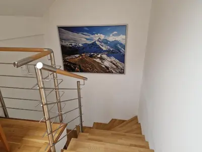 a stairway with a picture of a mountain on the wall at Mountain peaks Apartment with Sauna in Gozd Martuljek