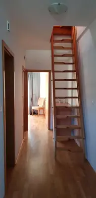 a staircase in a room with a living room at Mountain peaks Apartment with Sauna in Gozd Martuljek