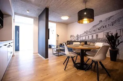 a kitchen and dining room with a table and chairs at Postcard City Apartments in Maribor