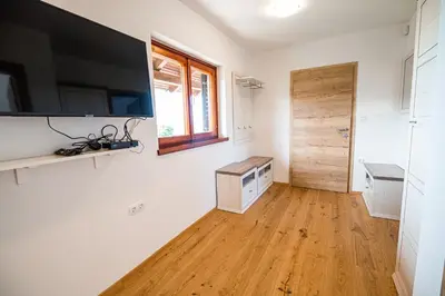 a living room with a large television on the wall at Holiday Home Kerin in Cerklje ob Krki