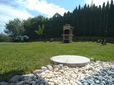 a rock garden with a grill in a field at Sunrise Home in Maribor