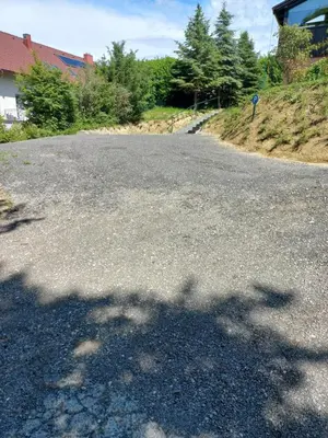 an empty road with a tree shadow on it at Sunrise Home in Maribor