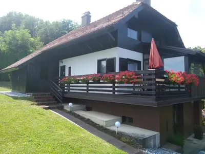 a house with a balcony with flowers on it at Sunrise Home in Maribor