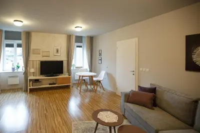 a living room with a couch and a table at Apartment Nobl plac in Celje