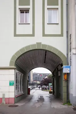 an entrance to a building with an archway at Apartment Nobl plac in Celje