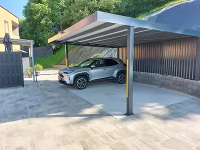 a small car parked under a parking lot at Apartments Alexandra in Celje
