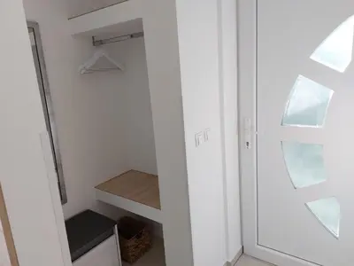 a small closet with a door and a shelf at Apartments Alexandra in Celje