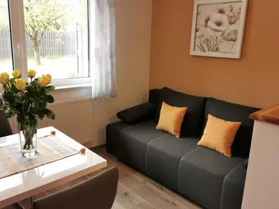 a living room with a couch and a table at Apartments Alexandra in Celje
