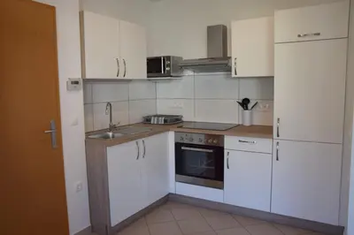 a kitchen with white cabinets and a sink at COMFY and BRIGHT Apartment in Kranj