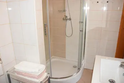 a bathroom with a shower with a glass door at COMFY and BRIGHT Apartment in Kranj