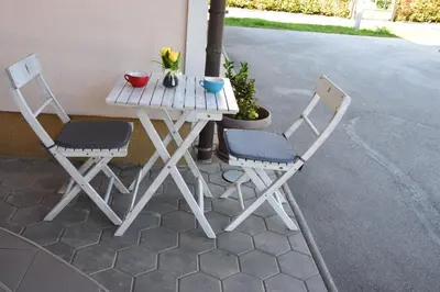 a table and two chairs sitting on a patio at COMFY and BRIGHT Apartment in Kranj