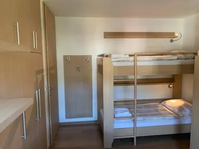 a room with three bunk beds in a room at Apartment MIMI in Kranjska Gora