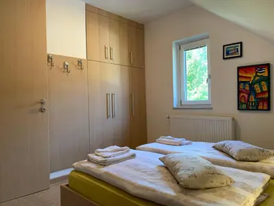 a bedroom with two beds and a window at Apartment MIMI in Kranjska Gora