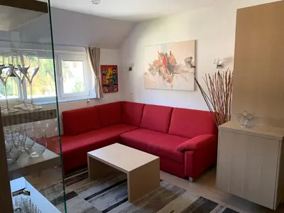 a living room with a red couch and a table at Apartment MIMI in Kranjska Gora