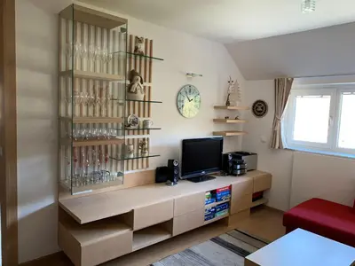 a living room with a tv on a shelf at Apartment MIMI in Kranjska Gora