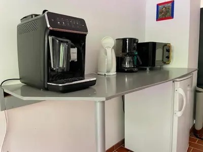 a table with a microwave and other appliances on it at Bohinj Barn in Bohinj