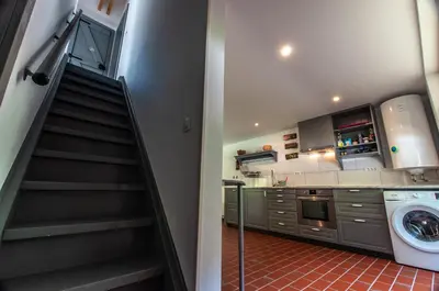 a staircase in a kitchen with a washing machine at Bohinj Barn in Bohinj